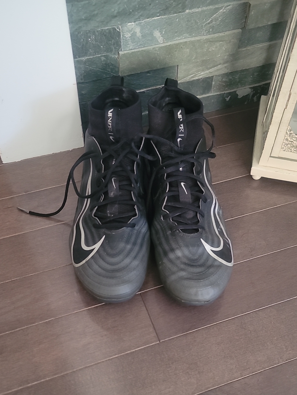 Nike Black High-Top Cleats with Silver Swoosh Accents